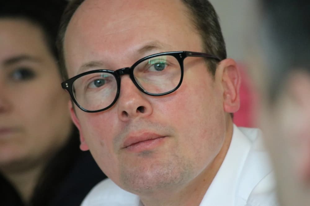 Close up of professional man listening at conference