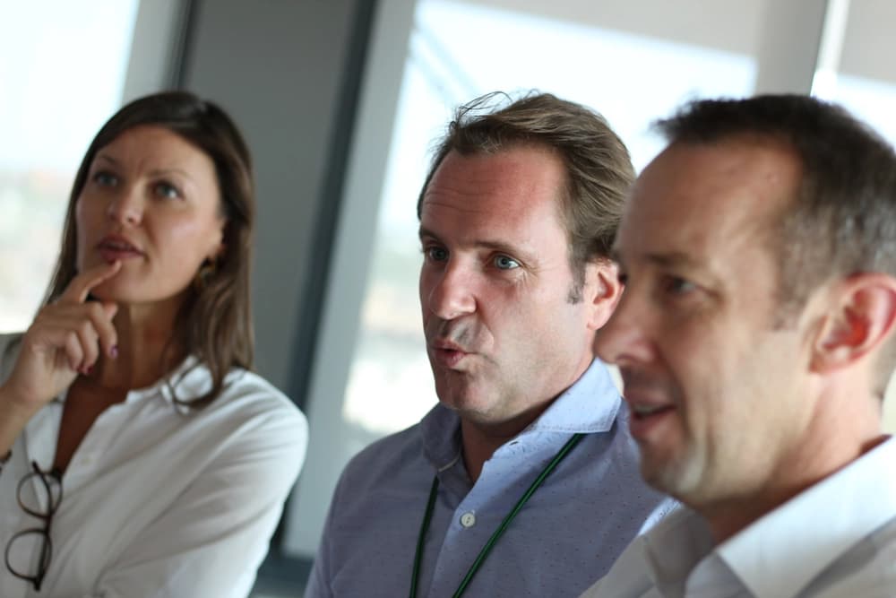 3 professional people at a Heineken corporate conference in Madrid