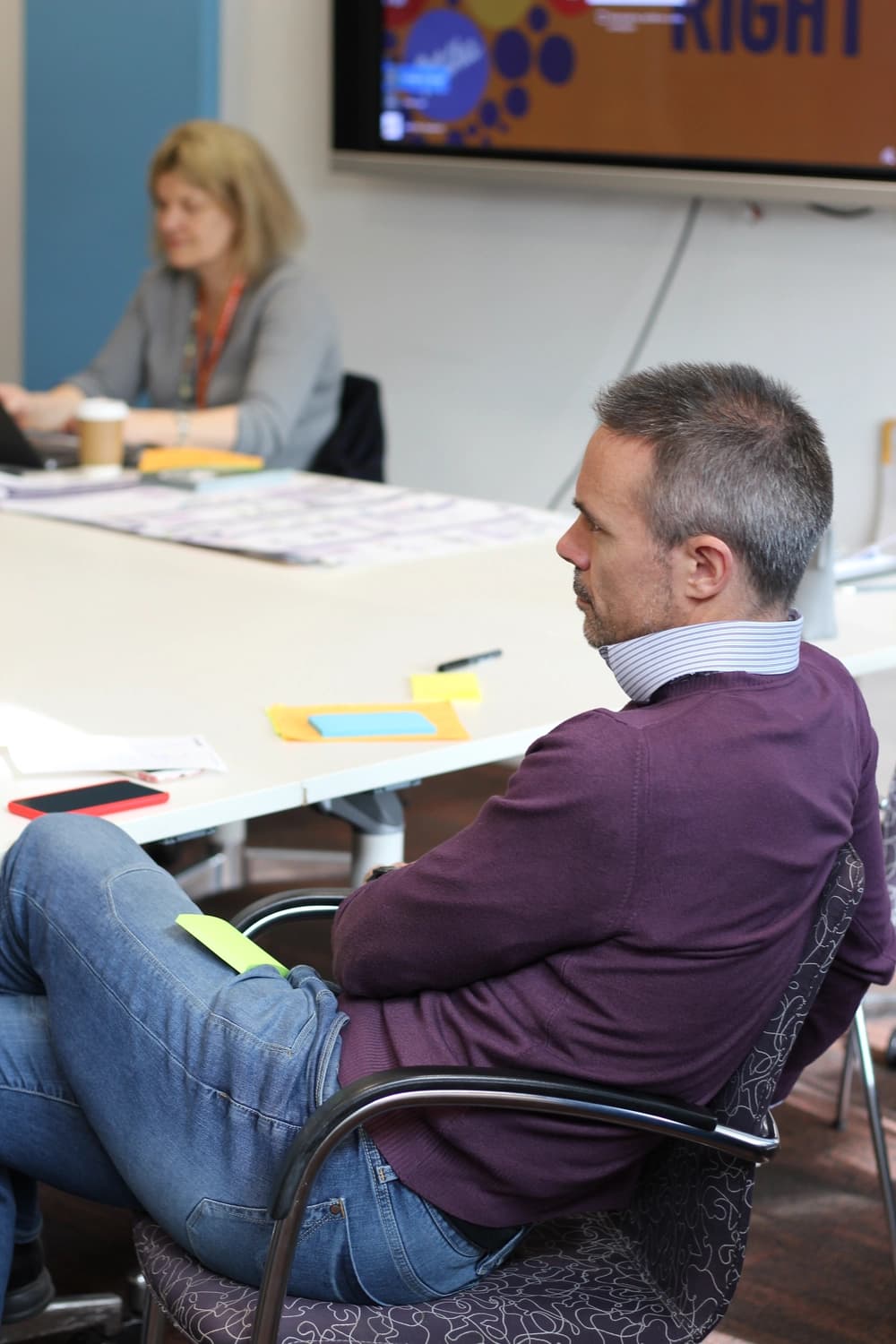 Man listening to speaker at conference