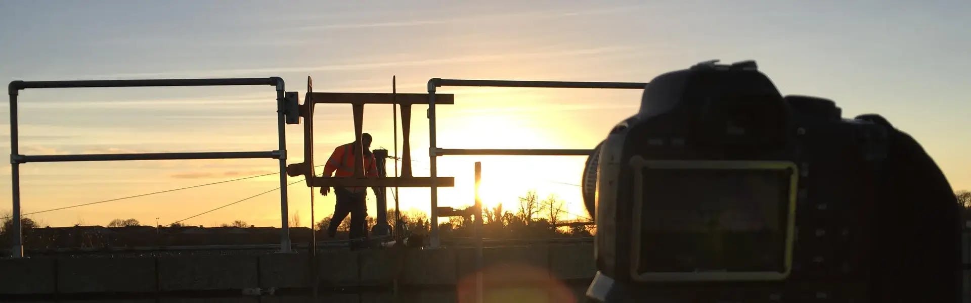 Sunset shot of worker operating water filtering equipment on training film shoot