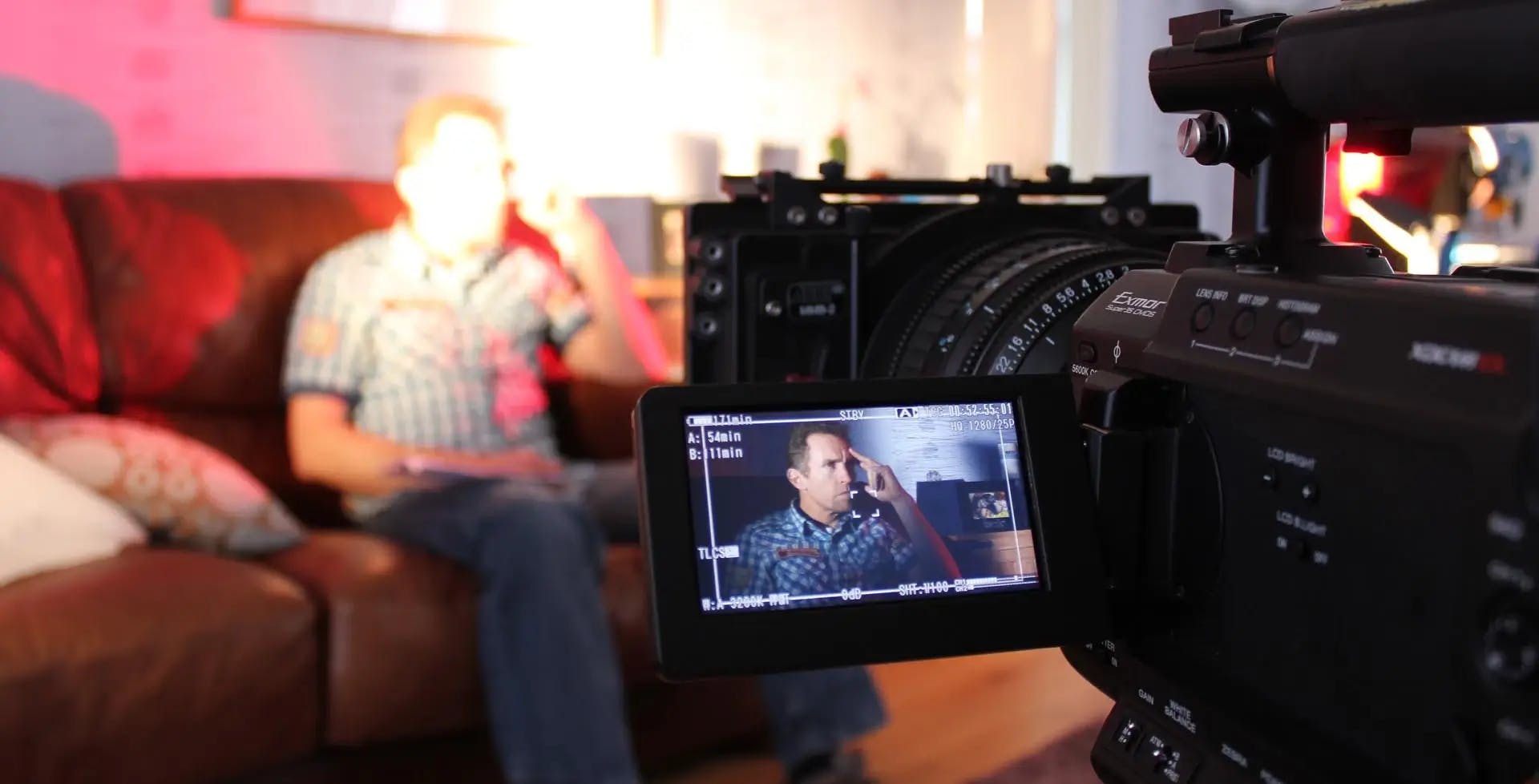 Soft focus shot of High quality camera filming interview with an actor for a training film