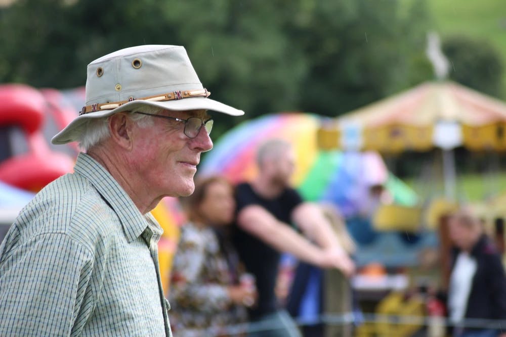 Older farmer watching activities at country show