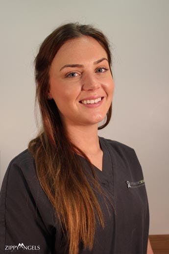 headshot of smiling young dental assistant